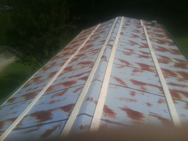 Rusted metal roof panels with new wood purlins before replacement — Storm Damage Roof Repair in Lake Como by Roofing Brothers