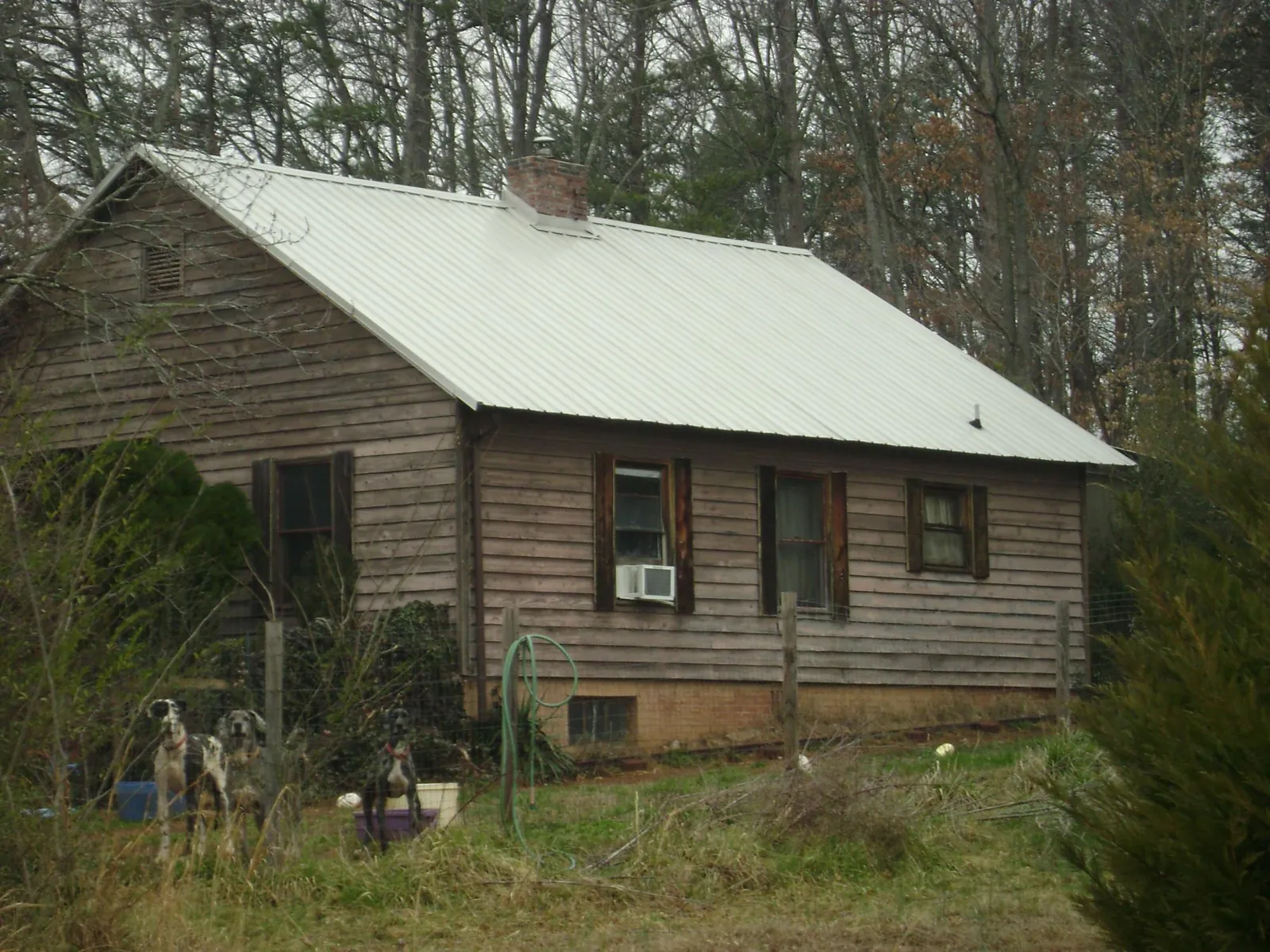 White metal roof on an old wood sided farmhouse, from a Metal Roof Installation job in Lake Como